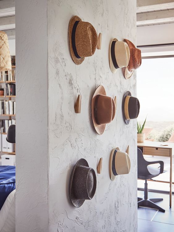 a textural wall with wooden hooks from IKEA is a pretty solution to hold your hats, it's a pretty solution for displaying hats