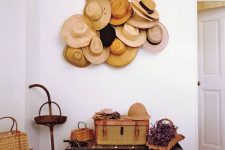 14 a vintage rustic entryway with chests, straw bags and a holder with lots of straw hats – they cover the holder easily