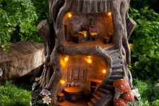 17 a tree stump renovated into a little outdoor elf or doll house with lights is a great idea for a rustic garden, make your kids happy with it