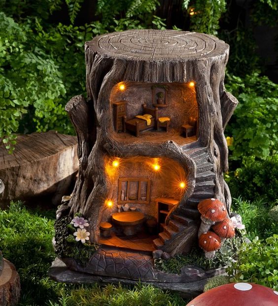 a tree stump renovated into a little outdoor elf or doll house with lights is a great idea for a rustic garden, make your kids happy with it