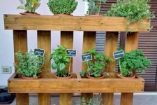 22 a vertical kitchen garden composed of wood, with lots of planters and chalkboard markers is a lovely idea for any small space, indoor or outdoor