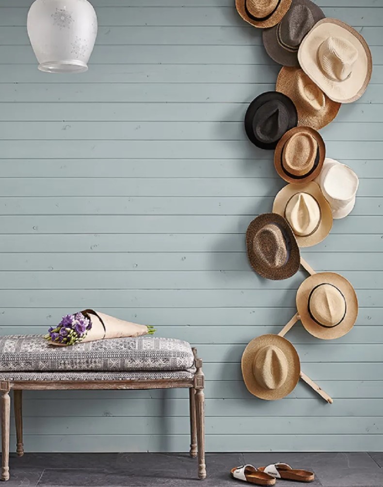 a creative hat holder made of a zigzag wooden plank with hooks is a lovely idea for your entryway, and hats will hide this plank