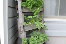 24 a vertical tiered garden of reclaimed wood, with lots of greenery and plants is a lovely solution for a rustic outdoor space