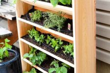 25 a vertical wooden planter with tiers is a lovely idea for growing herbs and plants and looks very cozy and rustic