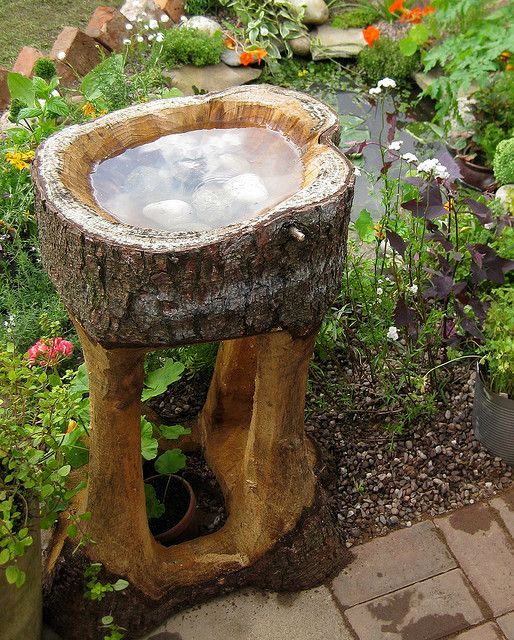 a stand with a bird bath made of an tree stump is a lovely idea for a rustic garden, you can make one easily