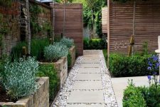 35 tall brick garden beds with greenery, trees in between them and some greenery around the entrance are a great combo if you have literally no space for the garden