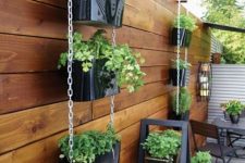 36 tiered vertical planters with greenery and a ladder with planters are a simple and cool way to refresh the space and make it greener
