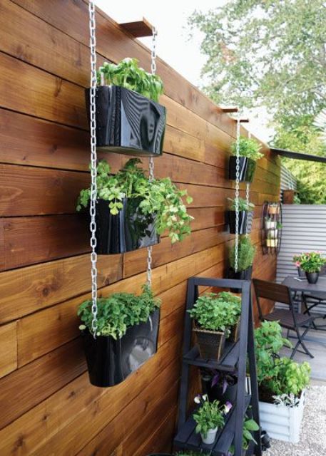 tiered vertical planters with greenery and a ladder with planters are a simple and cool way to refresh the space and make it greener tiered vertical planters with greenery and a ladder with planters are a simple and cool way to refresh the space and make it greener