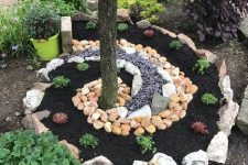 12 a creative swirl garden bed surrounding the tree, with various types of rocks and pebbles is a very cool solution