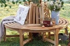 13 a classic wooden wrap around bench for a tree, with blankets, pillows and wire baskets is a lovely rustic decor idea