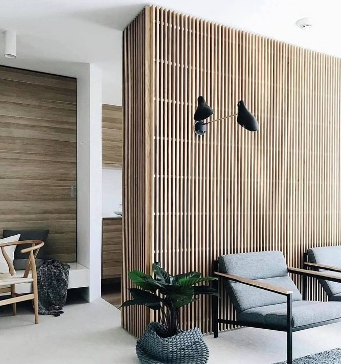 a mid-century modern interiors with plenty of stained wood incorporated - a wood slat accent wall and wood clad walls in other spaces