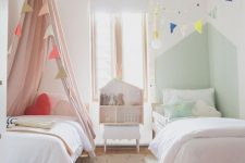 38 a small shared kids’ room with a pink and a green bed and nook, banners, a playhouse, a rug and some simple toys