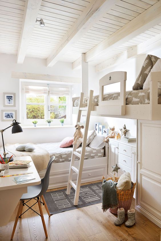 a small shared kids' room with a raised and usual bed, a ladder, printed bedding, a white desk and a black chair