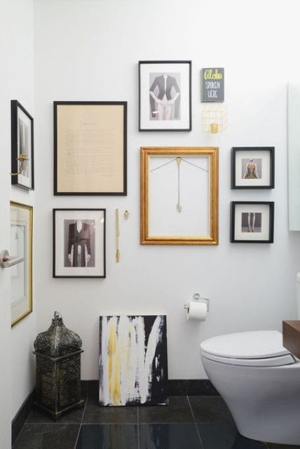 a black and white mudroom with a quirky gallery wall that flows from one wall to another and a candle lantern