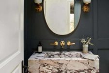 a luxurious black bathroom with a marble sink