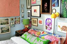 a maximalist gallery wall in various bright colors, with mismatching frames taking two walls looks very bold and cool