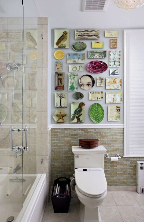 a modern bathroom with earthy tone tiles, a colorful gallery wall created of plates that brings fun and interest to the space