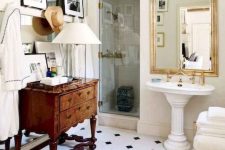 a neutral vintage bathroom with a checked floor, a vintage stained dresser, a free-standing sink, a gallery wall and a mirror
