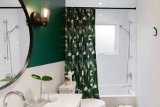 a stylish small bathroom with a green and white tile wall, a grey hex tile floor, a floating timber vanity and a tropical print curtain