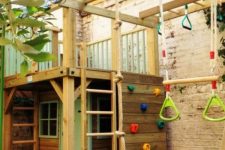10 a fun and colorful backyard with a climbing wall, a swing, a little playhouse with a ladder and some windows