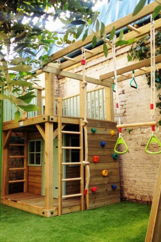 a fun and colorful backyard with a climbing wall, a swing, a little playhouse with a ladder and some windows a fun and colorful backyard with a climbing wall, a swing, a little playhouse with a ladder and some windows