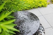 17 a modern bowl fountain surrounded with pebbles and super bold grasses and grasses is a lovely idea for a modern garden