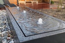 18 a modern box fountain with a black metal box surrounded with pebbles is a lovely addition to a modern garden space