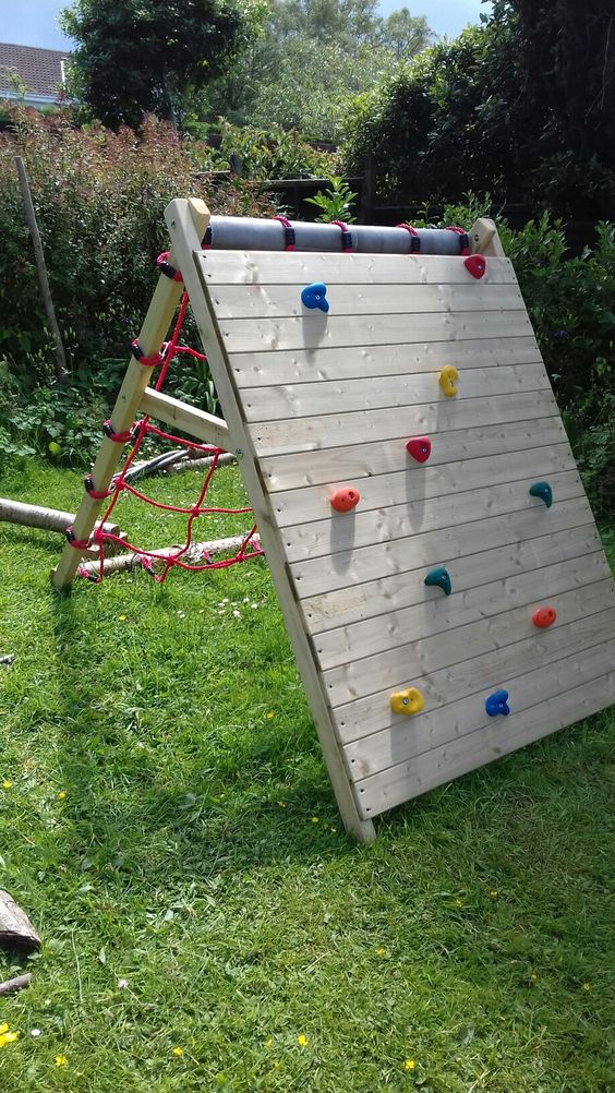 a smart folding climbing wall a folding piece featuring a climbing wall and a netting one is a cool and bold idea for a garden and you can remove it anytime