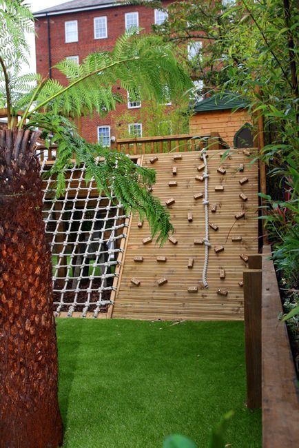 a kids' outdoor play complex with a climbing and rope wall, with a slide and a woven part is a very creative and fun idea to rock