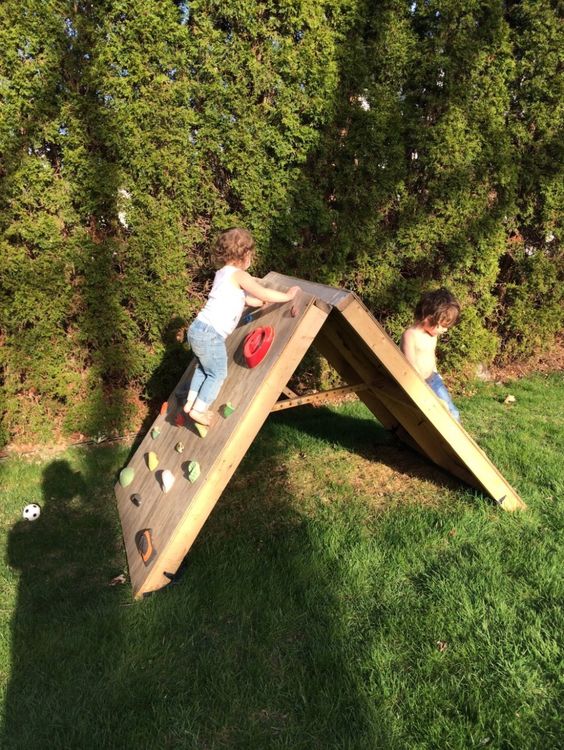 a wooden backyard climbing wall can be folded and hidden anytime, it's a great idea to save space and to hide it in winter