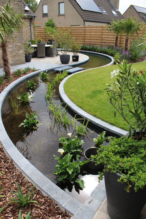 an ultra-modern curved water garden of greenery and white blooms is an amazing idea for a modern garden