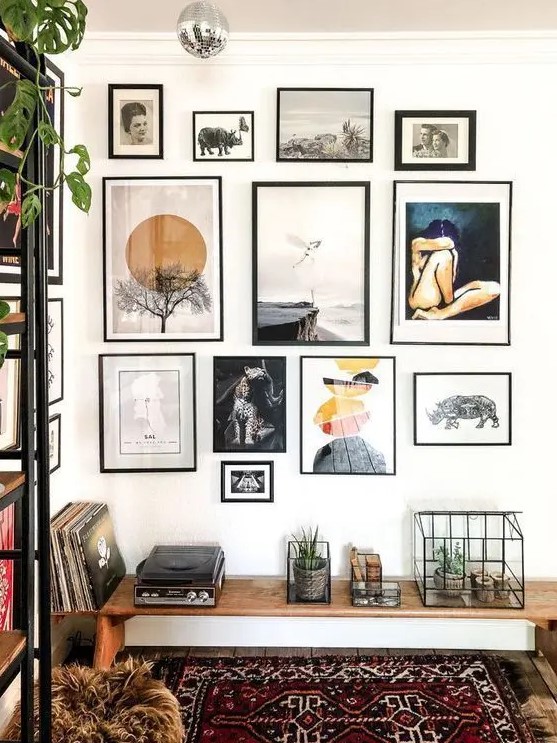 a beautiful gallery wall with various art, with mismatching black frames will add interest to your boho space