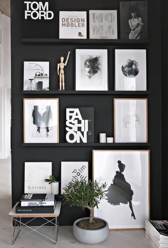 a black wall plus black ledges that merge with the wall and make the bold black and white artworks look floating in the air