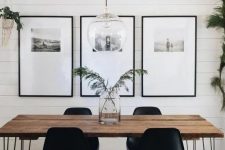 a bold grid gallery wall with thin black frames, a lot of matting and black and white photos placed in the top part
