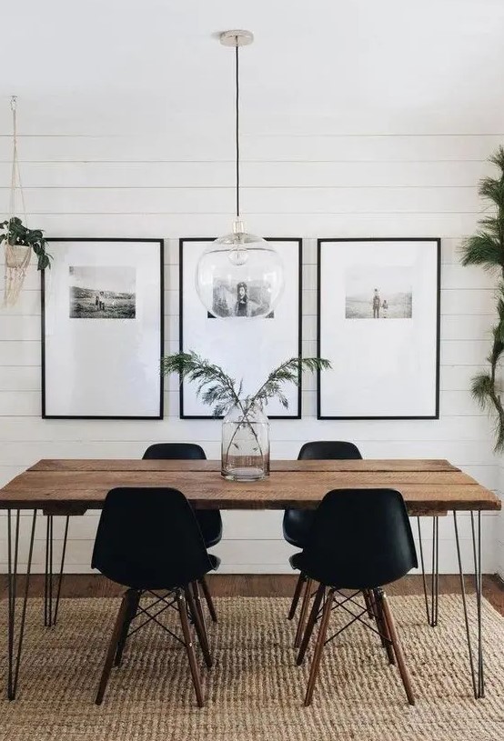 a bold grid gallery wall with thin black frames, a lot of matting and black and white photos placed in the top part