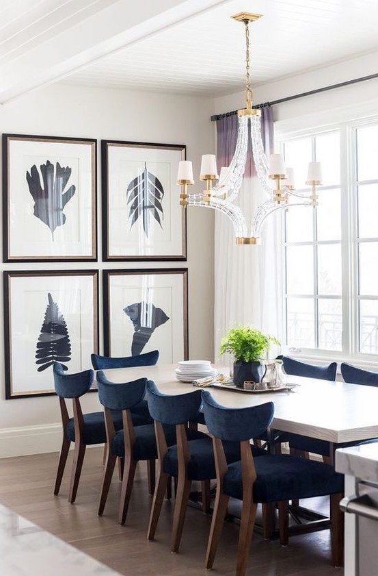 a bold modern gallery wall with dark frames and black silhouette art is a cool way to add personality to your space