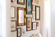 a chic free form gallery wall with vintage frames and colorful art of various kinds plus a clock is catchy