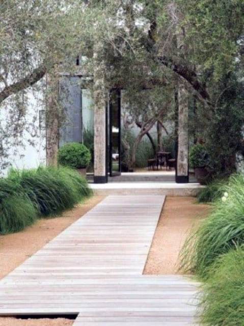 a contemporary whitewashed wooden planked walkway is a great idea for a modern, contemporary or minimalist outdoor space