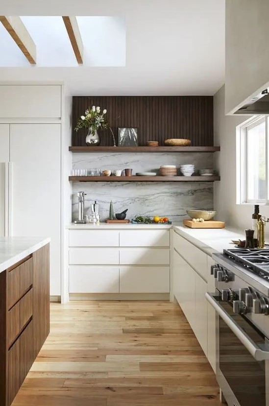 a cozy contemporary kitchen with sleek white and dark stained cabinets, a white stone backsplash and white countertops