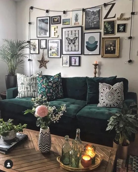 a creative boho gallery wall with mismatching art in various frames accented with additional lights is super cool