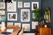 a free form gallery wall with framed and non-framed artworks, posters and prints plus some wall sconces is pure chic