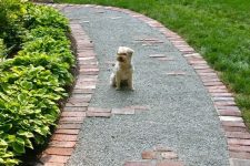 a gravel pathway lined with red bricks is a stylish and timeless idea, and your gravel won’t finish on the lawn