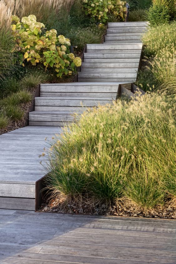 a laconic weathered wood wooden walkway with steps is a lovely idea for a rustic space, it feels a bit coastal and relaxed a laconic weathered wood wooden walkway with steps is a lovely idea for a rustic space, it feels a bit coastal and relaxed