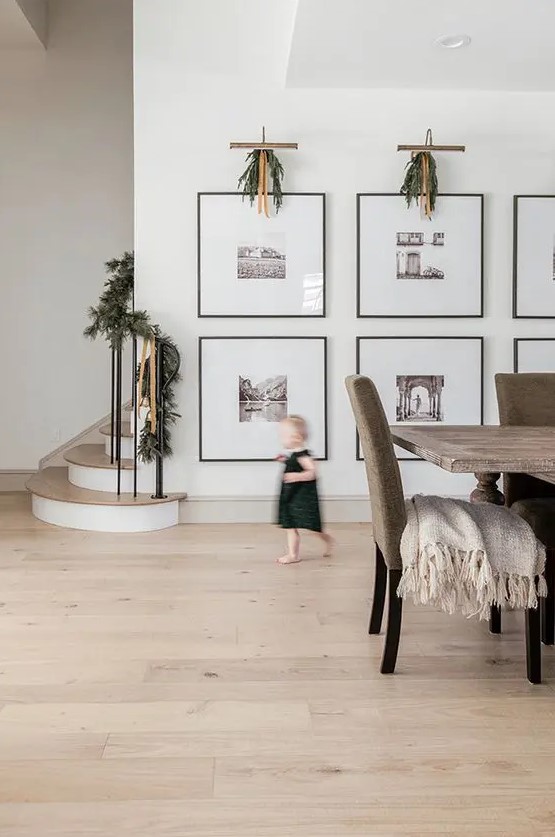 a large gallery wall with thin black frames, large matting and black and white photos is a very artful idea