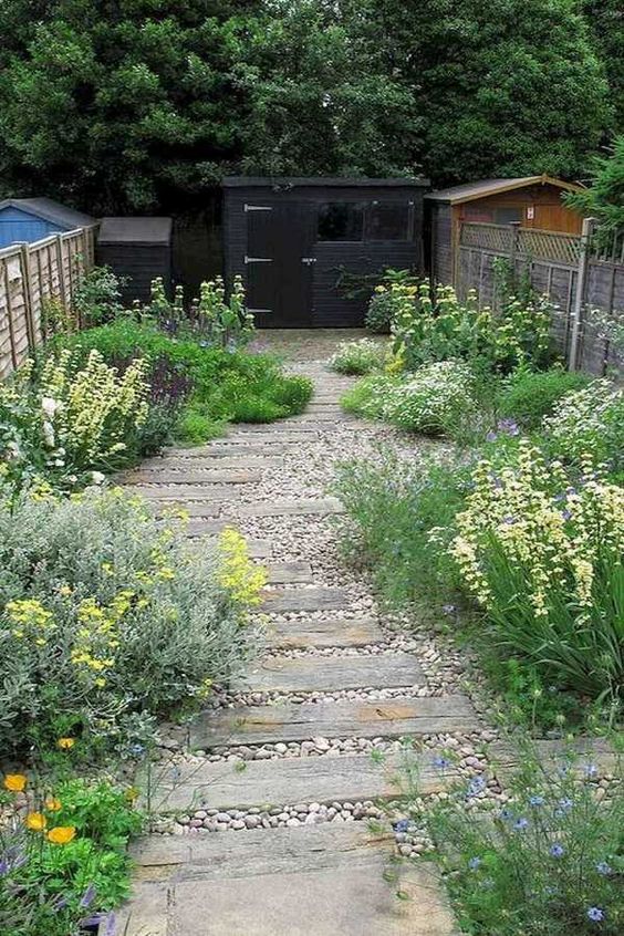 a lovely and simple garden with neutral pebbles, with greenery and blooms around is a cool idea for a rustic and relaxed outdoor space