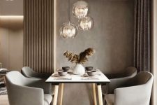 a lovely and welcoming taupe dinign zone with taupe walls, paneling and curtains, a simple table and grey chairs plus pendant lamps
