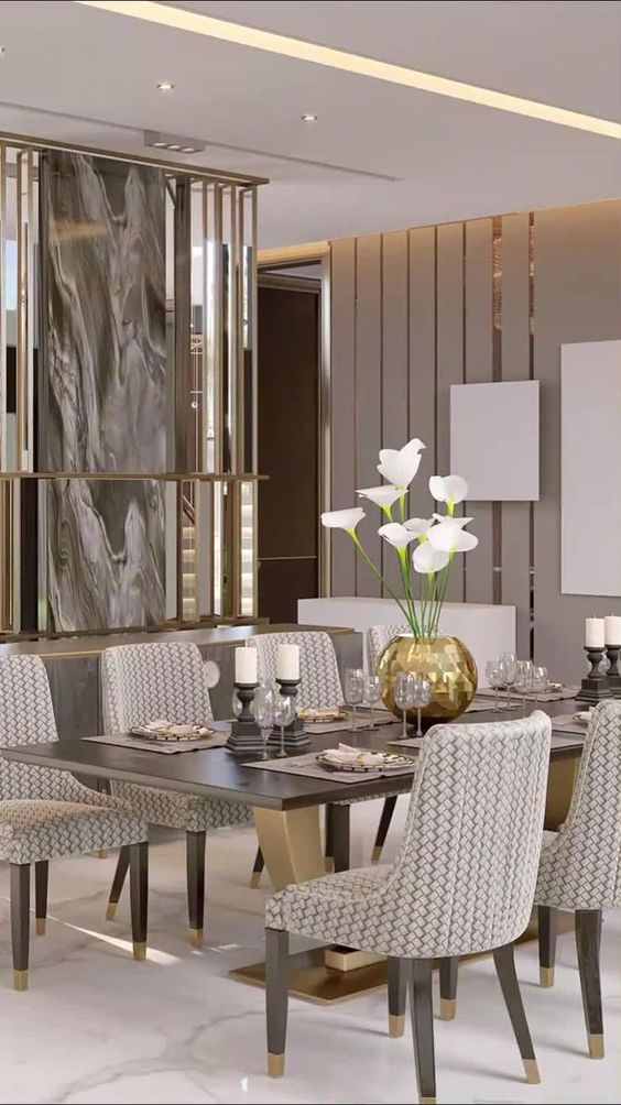 a luxurious and chic taupe dining room with a mirror accent wall, a striped wall, a chic dining table and printed chairs, candles and a lovely centerpiece
