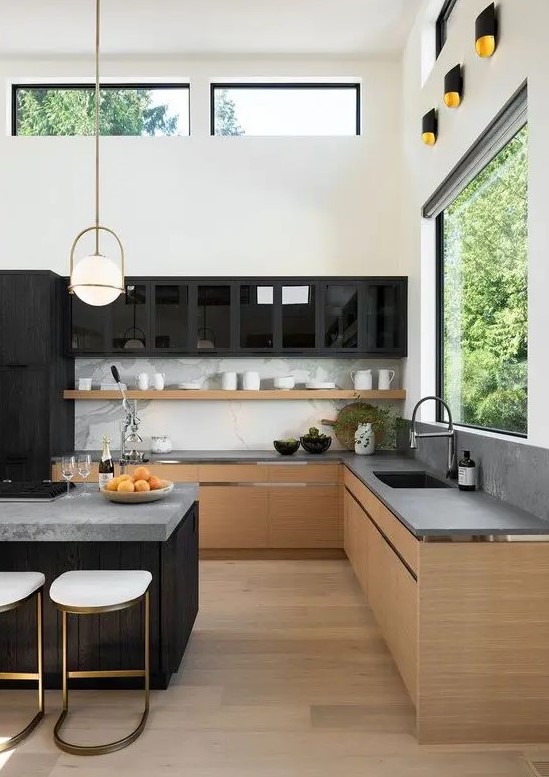 a minimalist kitchen with contrasts, with stained cabinets, concrete countertops and a backspalsh, black upper cabinets and a large kitchen island with seats