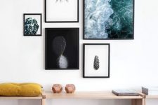 a modern free form gallery wall with mismatching frames and ultra-modern artworks and prints looks fresh and bold