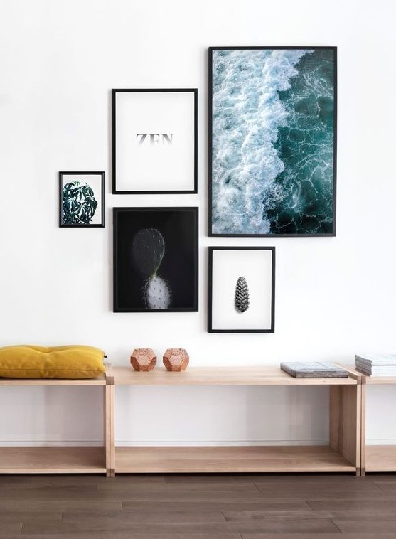 a modern free form gallery wall with mismatching frames and ultra-modern artworks and prints looks fresh and bold